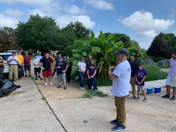 A man is standing in front of a group of people