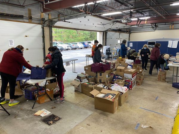 Sol Levinson, JVC and community volunteers sorting hundreds of books from our immensely successful Book Drive.