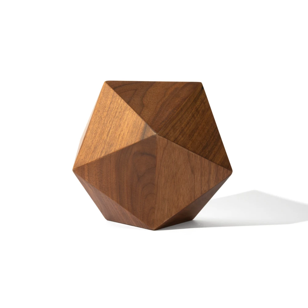 Faceted walnut urn with a geometric silhouette